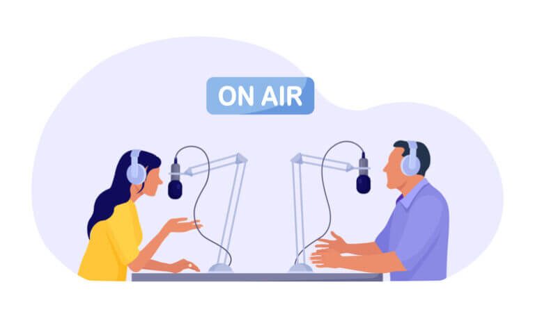 Man and woman in headphones talking to microphones recording podcast in studio.