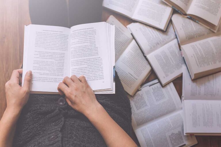 13 best books for leaders to read in 2018 7 open book laying on person's lap