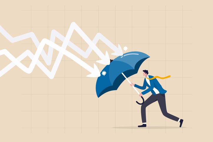 Why UX strategy in economic uncertainty helps companies thrive 6 illustration shows businessman holding umbrella to cover and protect from downturn arrow.