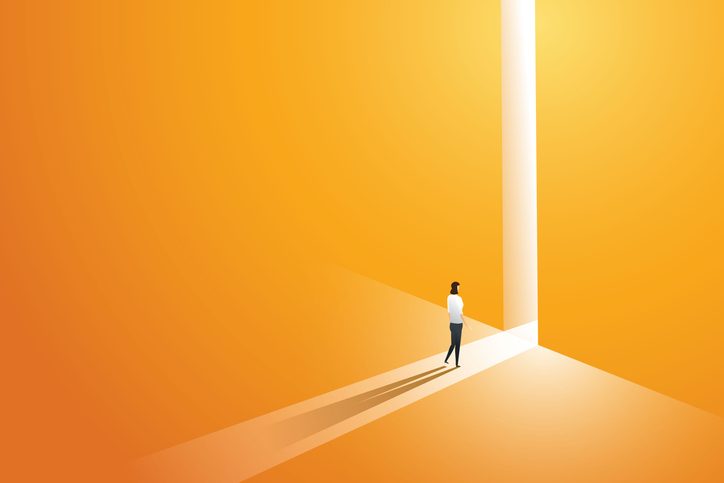 Illustration shows businesswoman walking go to front of bright big shining door in the wall for article to build effective UX teams